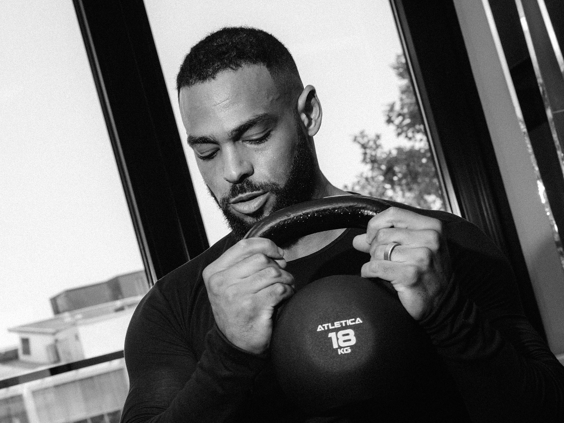 Anthony Green holding a kettlebell at his chest