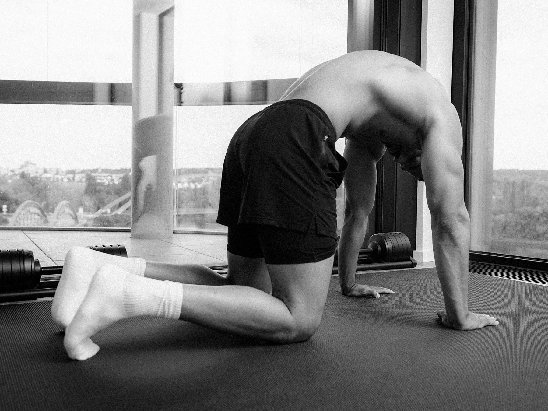 Anthony Green moving through a spinal flexion on a mat